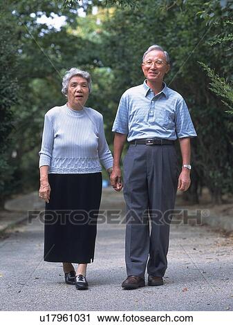 Senior adult man and woman walking together, Front View View Large Photo Image Stock Image - Senior adult man and woman walking together, Front View. Fotosearch