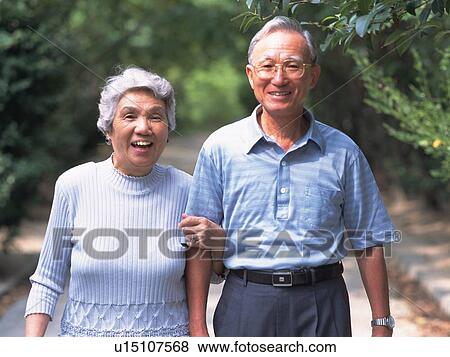 Senior adult man and woman walking together, Front View View Large Photo Image Stock Photo - Senior adult man and woman walking together, Front View. Fotosearch