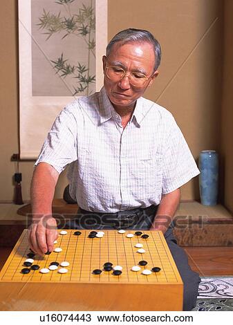 Senior adult man playing Go, Front View View Large Photo Image Stock Image - Senior adult man playing Go, Front View. Fotosearch