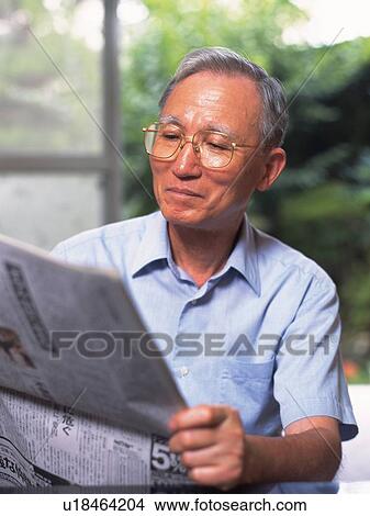 Picture - Senior adult man reading news paper, Front View. Fotosearch