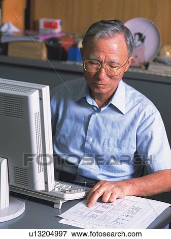 Senior adult man using a computer, High Angle View View Large Photo Image Stock Photo - Senior adult man using a computer, High Angle View. Fotosearch