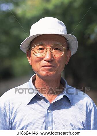 Stock Photography - Senior adult man with a hat smiling at camera, Front View. Fotosearch