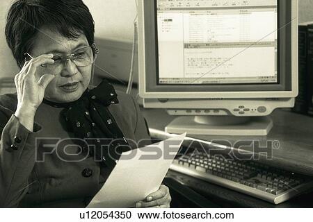 Senior adult woman reading documents, High Angle View, Black and White View Large Photo Image Stock Image - Senior adult woman reading documents, High Angle View, Black and White. Fotosearch