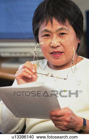 Senior adult woman reading documents, Front View View Large Photo Image Stock Image - Senior adult woman reading documents, Front View. Fotosearch