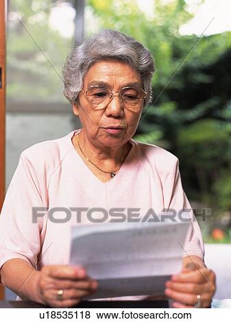 Senior adult woman reading letters, Front View View Large Photo Image Stock Photo - Senior adult woman reading letters, Front View. Fotosearch