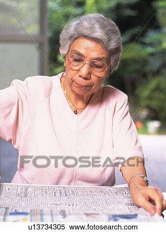 Senior adult woman reading news paper, Front View View Large Photo Image Stock Photography - Senior adult woman reading news paper, Front View. Fotosearch