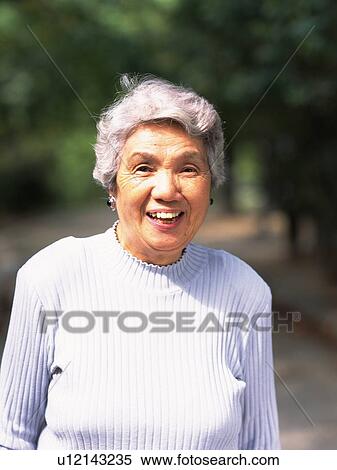 Stock Photography - Senior adult woman smiling at camera, Front View. Fotosearch