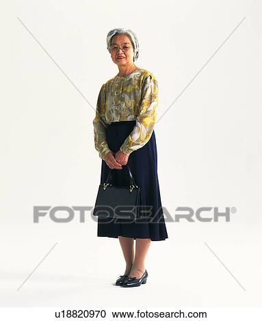 Stock Image - Senior adult woman standing, Front View. Fotosearch