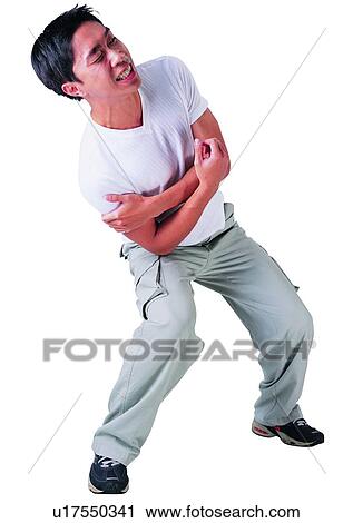 Stock Image - Casual Clothing, Indoor, Bending, One Person, Arms Crossed, Lifestyles, Young Adult. Fotosearch