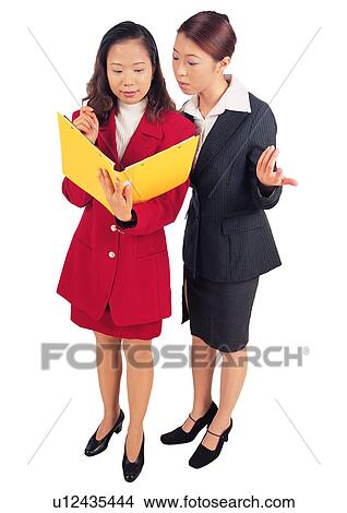 Cut Out, Asians At Work, Young Women, Looking Down, Reading, White Background View Large Photo Image Picture - Cut Out, Asians At Work, Young Women, Looking Down, Reading, White Background. Fotosearch