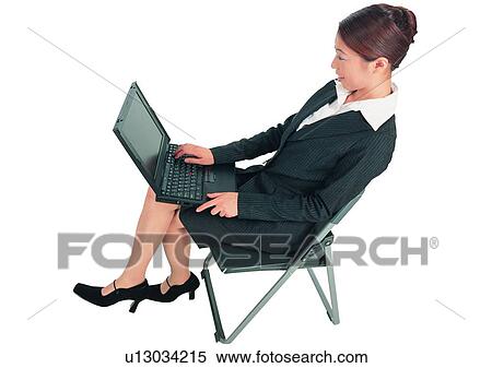 Stock Photography - White Background, Efficiency, Chair, One Young Woman Only, Clipping Path, Lifestyles. Fotosearch