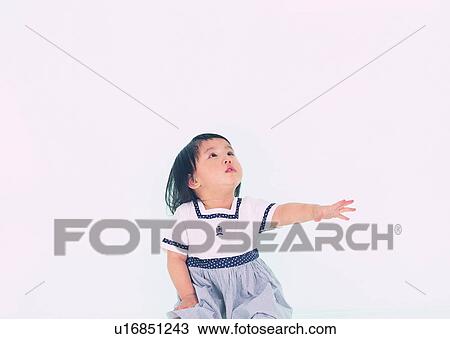 Stock Image - cute, lovely, kid, sitting, Asian, girl. Fotosearch