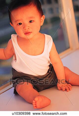 Stock Photo - lovely, baby, toddler, boy, sitting, Asian. Fotosearch
