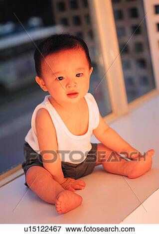Stock Photo - lovely, boy, sitting, baby, Asian, kid, child. Fotosearch