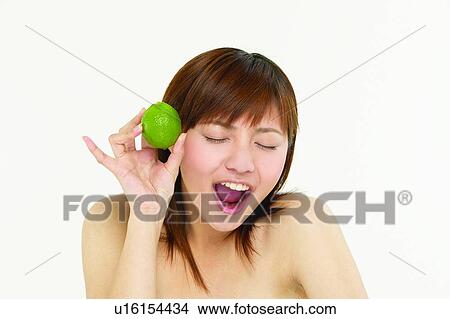 Beauty And Fruits, Lime, Beauty, Medium-Length Hair, One Young Woman Only, Eyes Closed, Close-Up View Large Photo Image Picture - Beauty And Fruits, Lime, Beauty, Medium-Length Hair, One Young Woman Only, Eyes Closed, Close-Up. Fotosearch