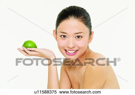 Stock Photography - Citrus Fruit, Head And Shoulders, Food And Drink, Beauty And Fruits, Black Hair, Lime, Asian. Fotosearch