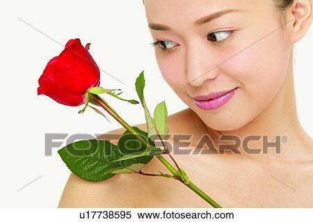 Stock Photography - Close-Up, Young Adult, One Young Woman Only, White Background, Petal, Indoor. Fotosearch