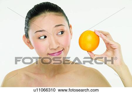 Stock Image - East, Beauty And Fruits, Eastern, Looking Sideways, Holding, One Person. Fotosearch