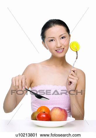 Stock Image - Fork, Holding, Hair Back, Knife, Food And Drink, Asian, Apple. Fotosearch