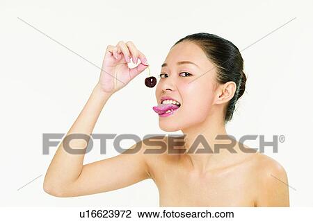 Stock Image - Freshness, Cherry, White Background, Close-Up, Sticking Out Tongue, Hair Back, Fruits. Fotosearch