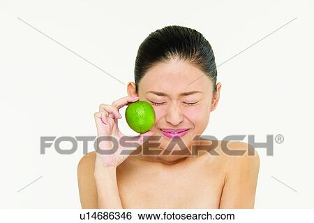 Stock Photograph - Fruits, Holding, Freshness, Beauty & Fruits, Healthy Eating, Hair Back. Fotosearch