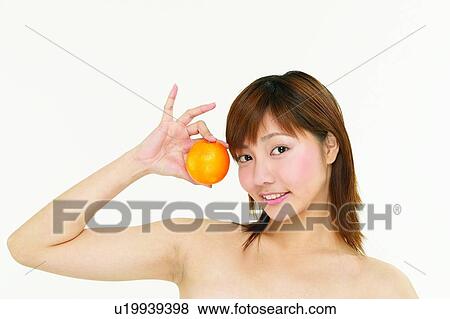 Stock Photo - One Young Woman Only, Happiness, Indoor, Orange. Fotosearch