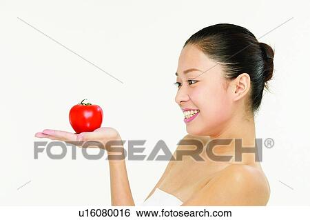 Stock Photograph - Portrait, Young Adult, Apple, Holding, Toothy Smile, Beauty, Black Hair. Fotosearch