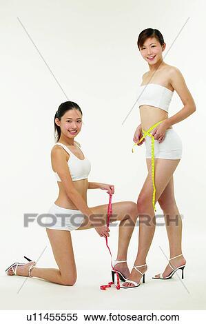 Stock Photography - Beauty Sports, Measuring Tape, Smiling, Sports Bra, Asian Ethnicity. Fotosearch