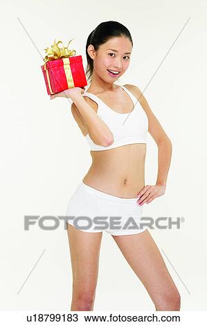 Stock Image - One Person, Wrapping Paper, Happiness, Smiling, Anticipation, Portrait, Hand On Hip. Fotosearch