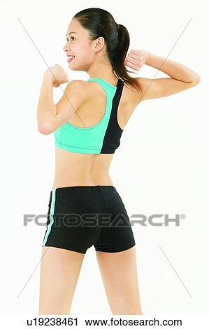 Stock Image - Smiling, Healthy Lifestyle, Looking Away, One Young Woman Only, Stretching. Fotosearch