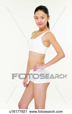 Stock Image - Sports Bra, Asian Ethnicity, 18-19 Years, Looking At Camera, Shorts, Young Adult, One Person. Fotosearch