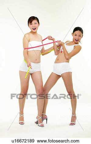 Two People, Measuring Tape, Sports Clothing, Female Bonding, Sports, Adults Only View Large Photo Image Stock Photo - Two People, Measuring Tape, Sports Clothing, Female Bonding, Sports, Adults Only. Fotosearch