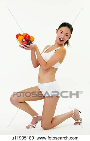 White Background, Beauty, Fruit, High Heels, Sports Bra, Indoor View Large Photo Image Stock Photo - White Background, Beauty, Fruit, High Heels, Sports Bra, Indoor. Fotosearch