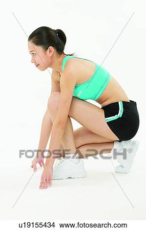 Picture - Young Adult, Leisure Activity, Sports Shoe, Exercising, Bending, Looking Away. Fotosearch