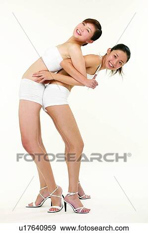 Stock Photo - Young Adult, Two People, Leisure Activity, Adults Only, Sports Bra. Fotosearch