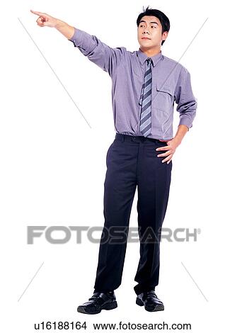 button down shirt, indoors, lifestyle, pointing, hand in air, style View Large Photo Image Picture - button down shirt, indoors, lifestyle, pointing, hand in air, style. Fotosearch