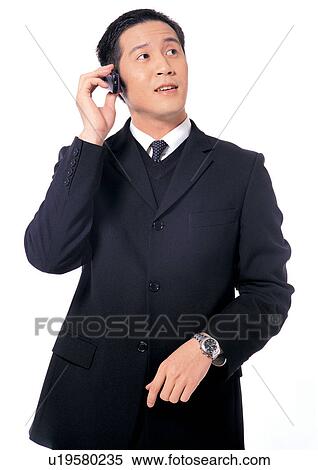 Stock Photography - style, fashion, suit, mobile phone, one person, executive, well dressed. Fotosearch