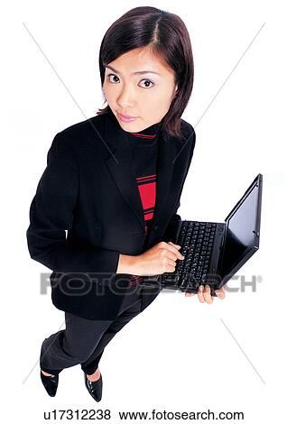 Stock Photo - young adult, style, business executive, indoors, well dressed, laptop. Fotosearch