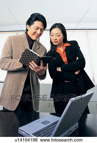 carefree, profession, cheerful, indoor, office desk, two people View Large Photo Image Stock Photo - carefree, profession, cheerful, indoor, office desk, two people. Fotosearch