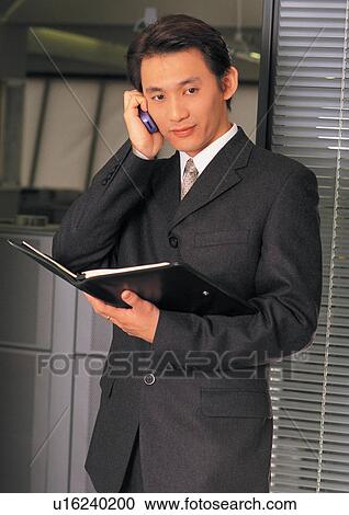 Stock Image - indoor, suit, connectivity, formal, businessman, occupation. Fotosearch