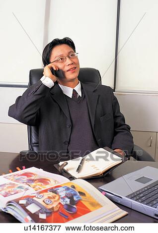 Stock Photo - on the phone, connectivity, communication, asian ethnicity. Fotosearch