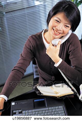 on the phone, connectivity, communication, asian ethnicity View Large Photo Image Stock Photo - on the phone, connectivity, communication, asian ethnicity. Fotosearch
