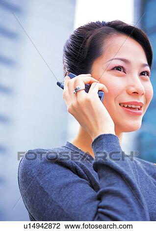 Stock Image - professional, asian ethnicity, office building, talking, blurred, cheerful, business executive. Fotosearch