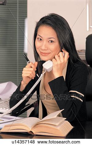 Stock Photo - professional, black hair, businesswoman, confidence, communication, talking, looking at camera. Fotosearch