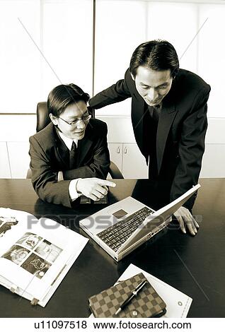 Stock Photo - sepia, asian ethnicity, well dressed, teamwork, business in asia, talking. Fotosearch