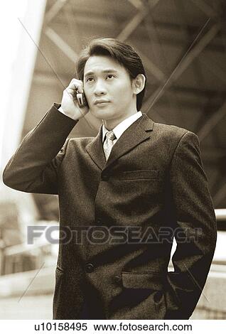 Stock Photography - sepia, asian ethnicity, well dressed, on the phone, business in asia, formal. Fotosearch