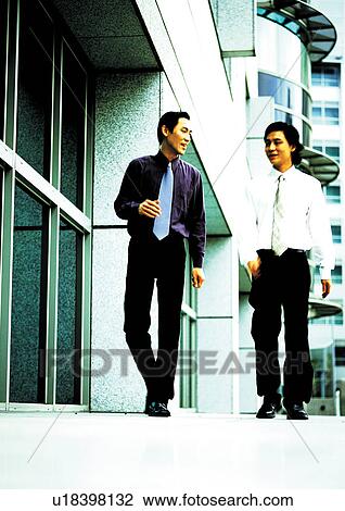 Stock Image - side by side, blurred, two people, walking, business. Fotosearch