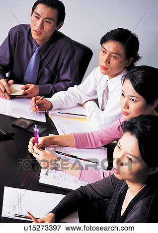 Stock Photo - well dressed, business in asia, teamwork, asian ethnicity. Fotosearch