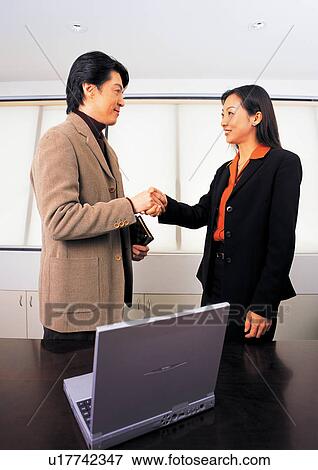 Stock Photo - well dressed, business in asia, teamwork, asian ethnicity. Fotosearch