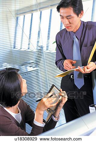young adult, businesswoman, business people, talking, businessman, pointing View Large Photo Image Stock Photo - young adult, businesswoman, business people, talking, businessman, pointing. Fotosearch